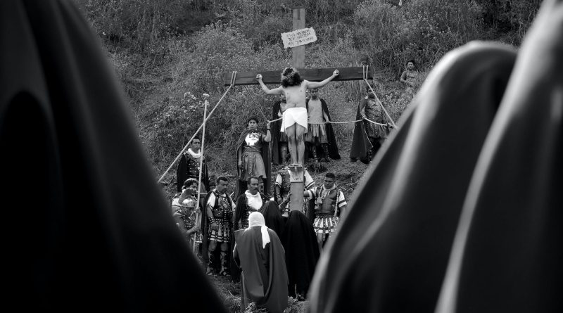 grayscale photo of a man nailed in the cross
